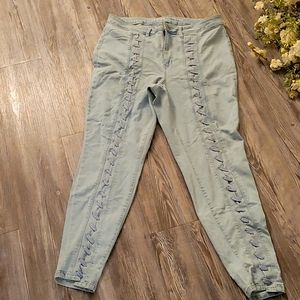NWOT Light washed skinny denim jeans with lace up front detail.